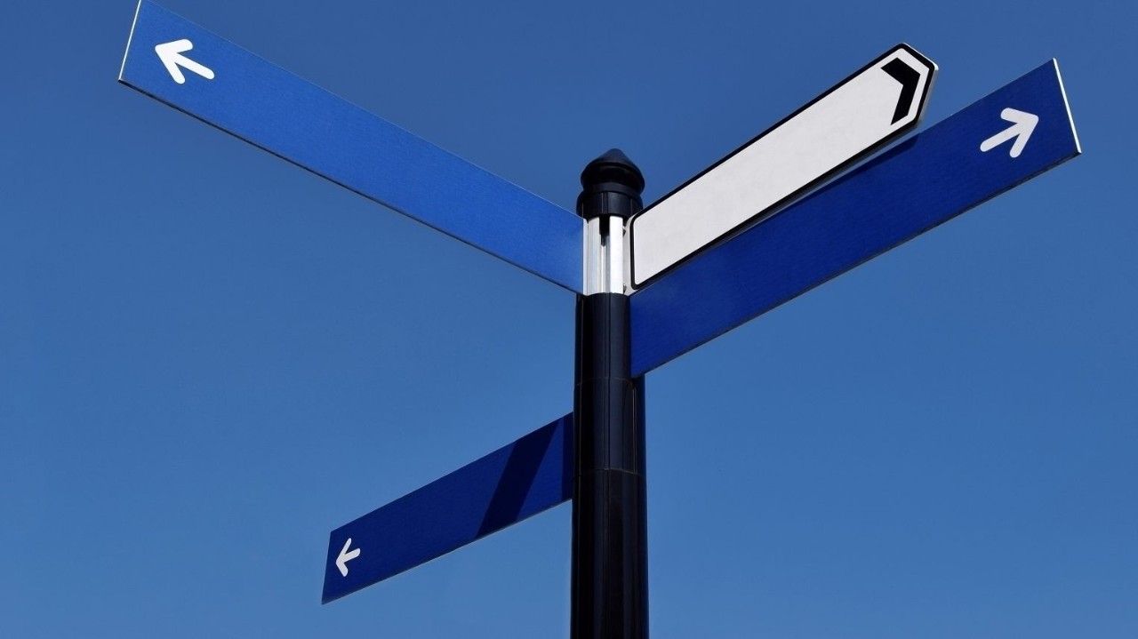 Unwritten road sign in the sunny day on the blue sky